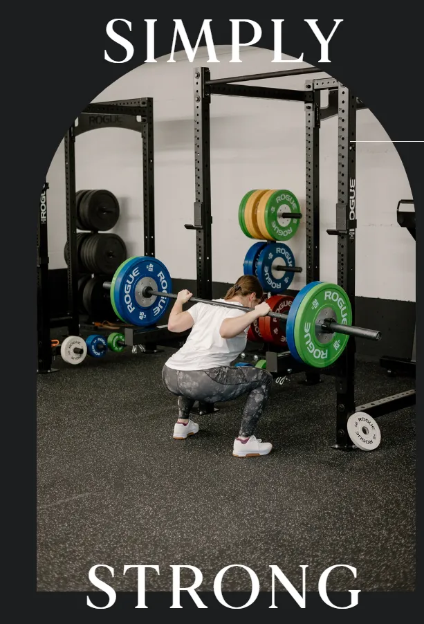 A lifter under the barbell on the Simply Strong Gym floor